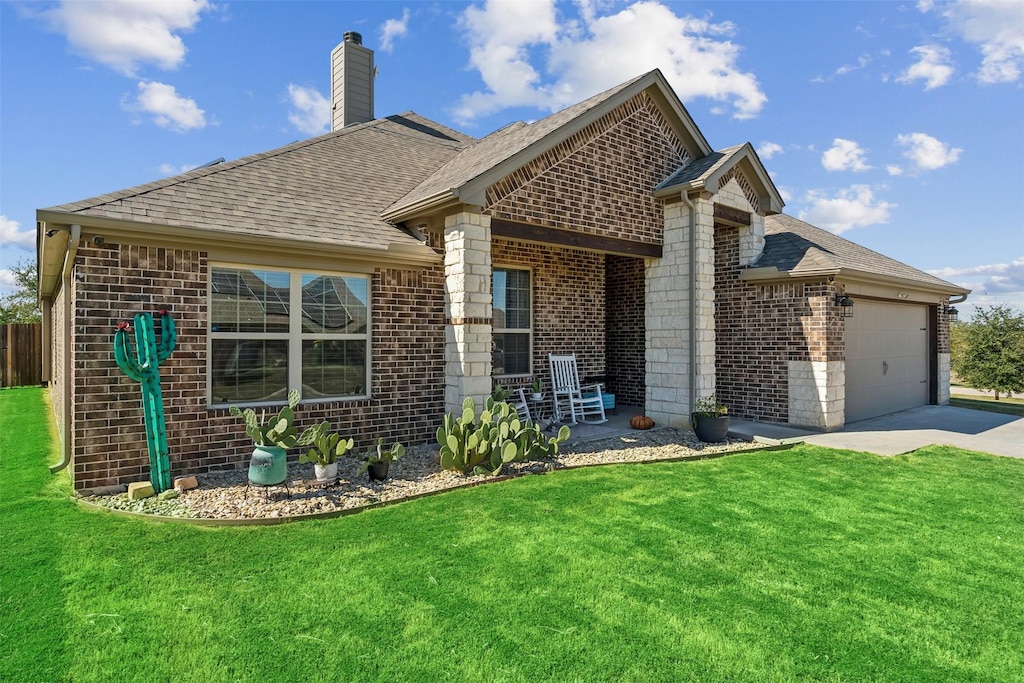 view of front of home with brick siding, an attached garage, and a shingled roof