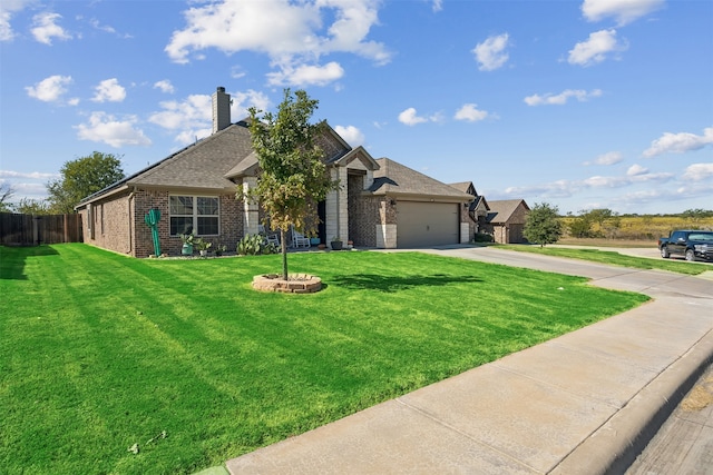 view of front of home featuring a front yard and a garage