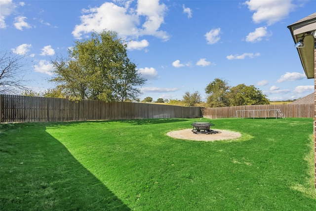 view of yard with a fire pit