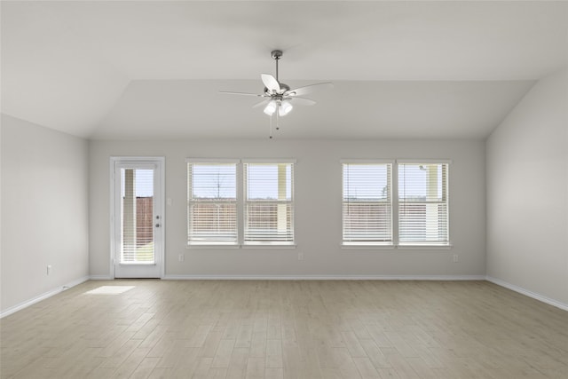 spare room featuring ceiling fan, light hardwood / wood-style floors, and vaulted ceiling