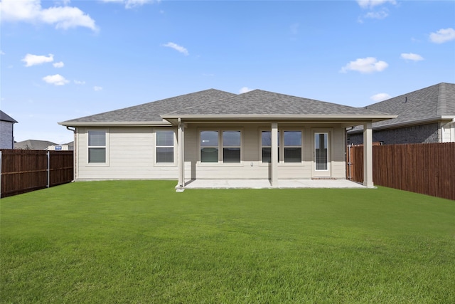 back of property featuring a patio area and a lawn