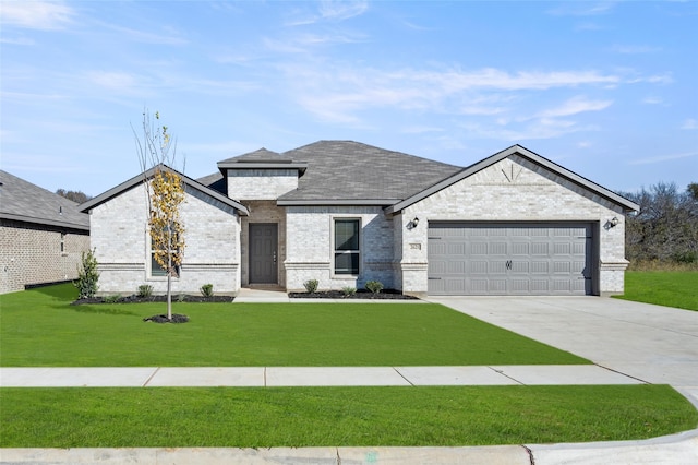 view of front of property with a front yard and a garage