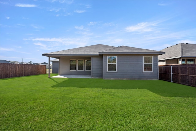 back of house featuring a yard and a patio