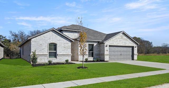 french country inspired facade featuring a front lawn, a garage, brick siding, and driveway