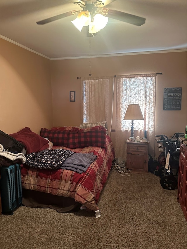 carpeted bedroom featuring ceiling fan and ornamental molding