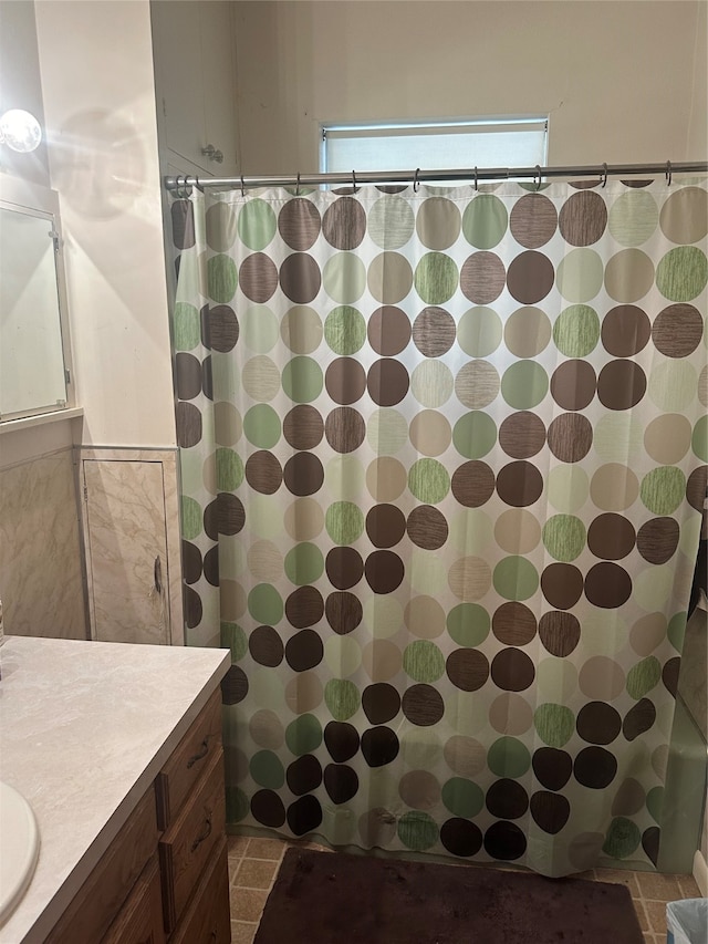 bathroom featuring vanity, a shower with curtain, and tile patterned flooring