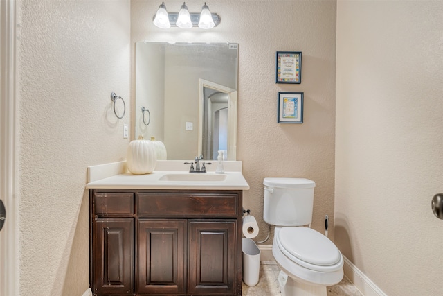 bathroom featuring toilet, vanity, and tile patterned floors