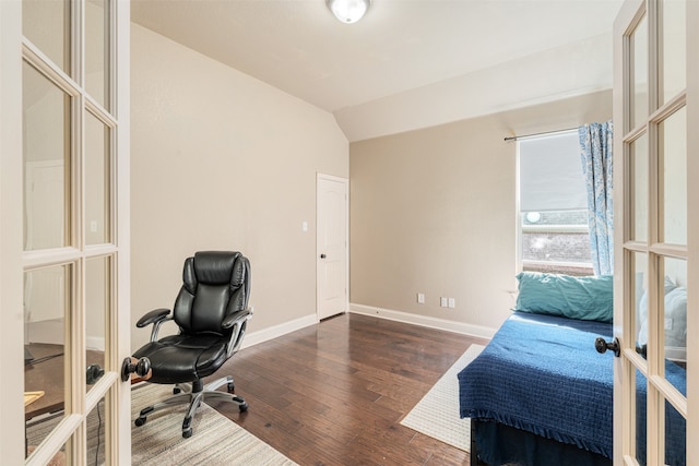 bedroom featuring french doors, dark wood-type flooring, and lofted ceiling