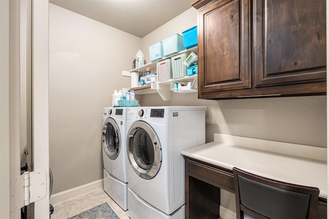 laundry area with washer and dryer, cabinets, a textured ceiling, and light tile patterned floors