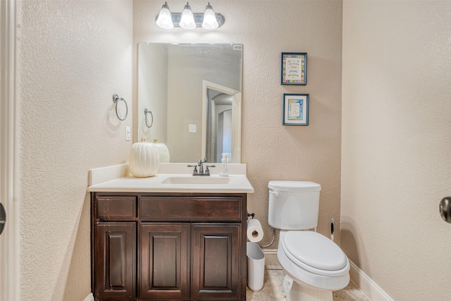 bathroom with toilet and vanity