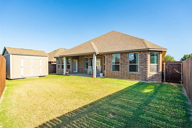 rear view of house featuring a lawn, a patio area, and a storage shed