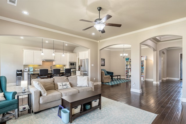 living room featuring baseboards, visible vents, wood finished floors, and ceiling fan with notable chandelier