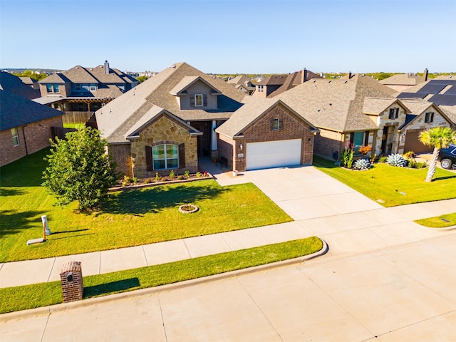 view of front of house with a front yard and a garage