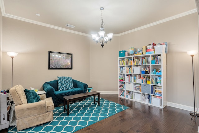 living area featuring a chandelier, dark hardwood / wood-style floors, and crown molding