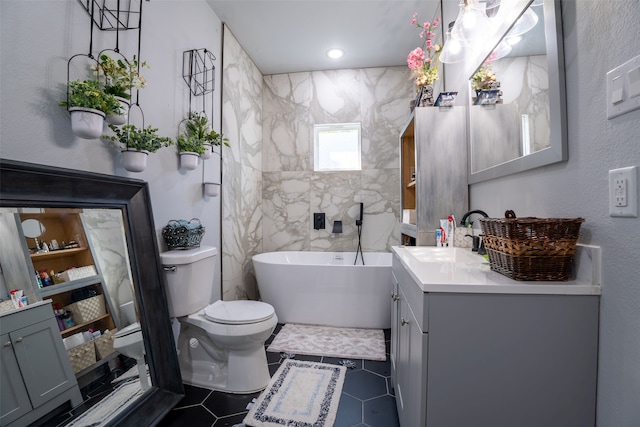 bathroom with vanity, a tub, tile walls, and toilet