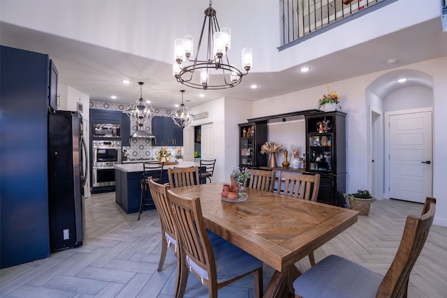 dining space featuring light parquet flooring and a high ceiling