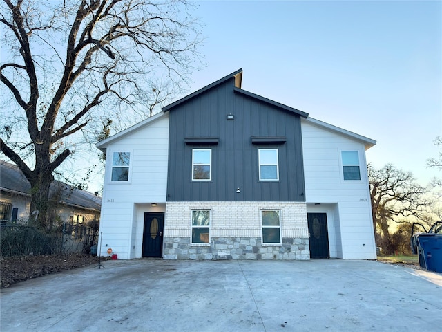 view of back house at dusk