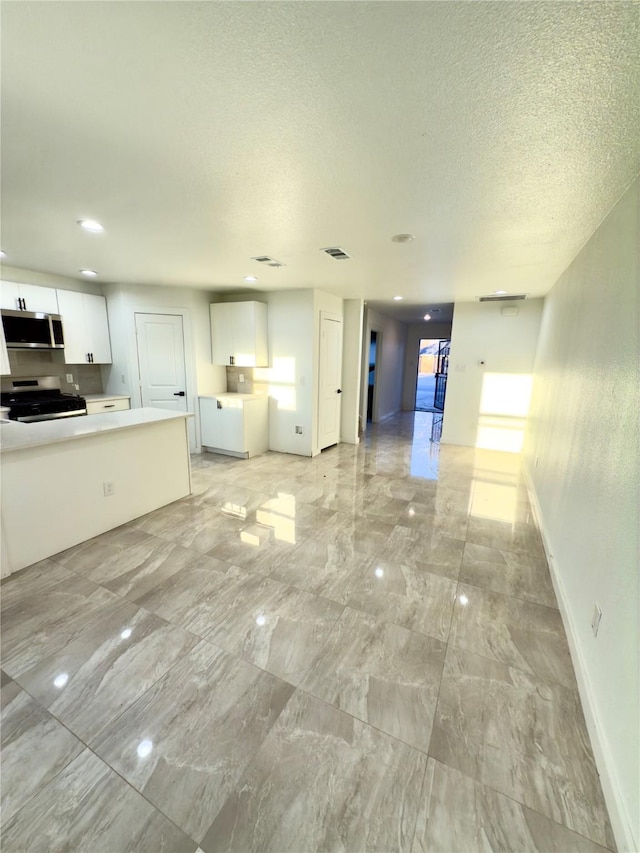 unfurnished living room featuring a textured ceiling