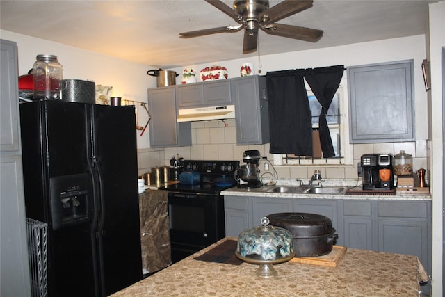 kitchen with decorative backsplash, gray cabinetry, ceiling fan, sink, and black appliances