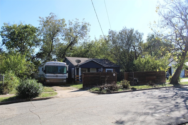 view of front of property with fence and driveway