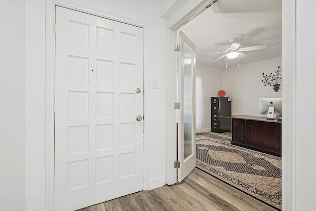 interior space featuring crown molding, hardwood / wood-style flooring, and ceiling fan