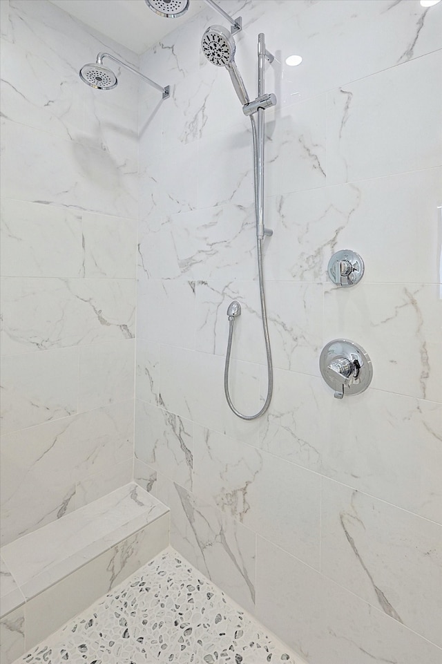 bathroom with a tile shower