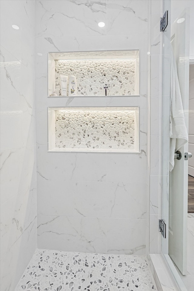 bathroom with tiled shower