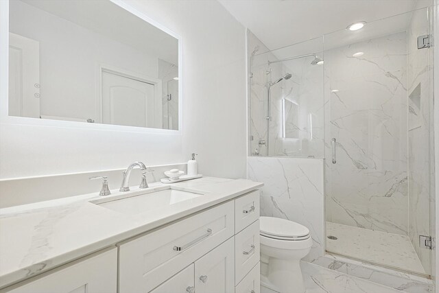 bathroom with vanity, toilet, and walk in shower