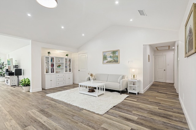 living room featuring high vaulted ceiling and wood-type flooring