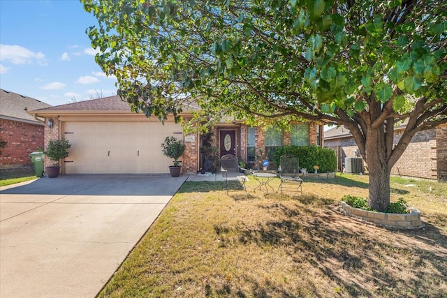 view of property hidden behind natural elements featuring a front yard, a garage, and cooling unit