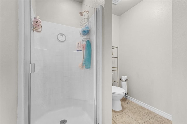 bathroom with toilet, tile patterned floors, and walk in shower