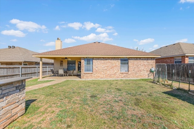 back of house with a patio, a lawn, and ceiling fan