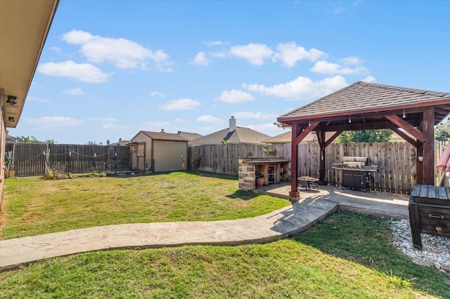 view of yard with a gazebo, a storage shed, and a patio