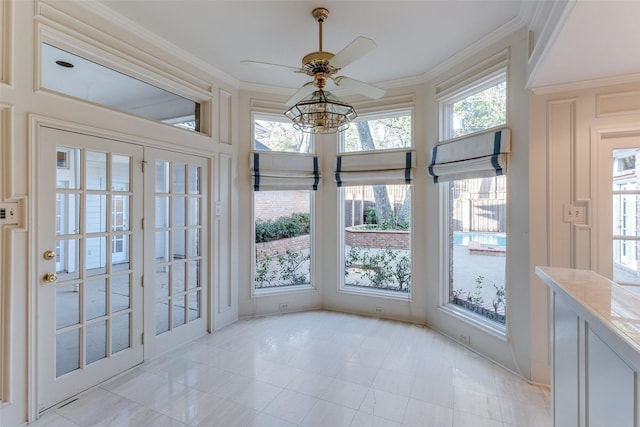 unfurnished sunroom with ceiling fan