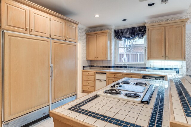 kitchen featuring crown molding, a center island, and light brown cabinets