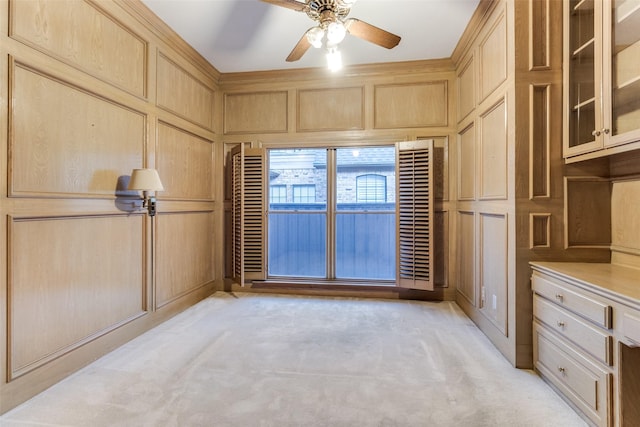 interior space with ceiling fan and wood walls