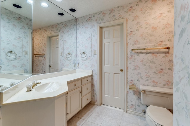 bathroom with vanity, tile patterned floors, and toilet