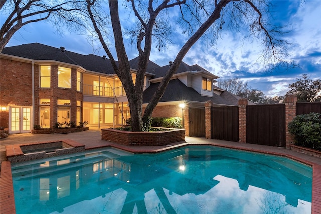 view of pool at dusk