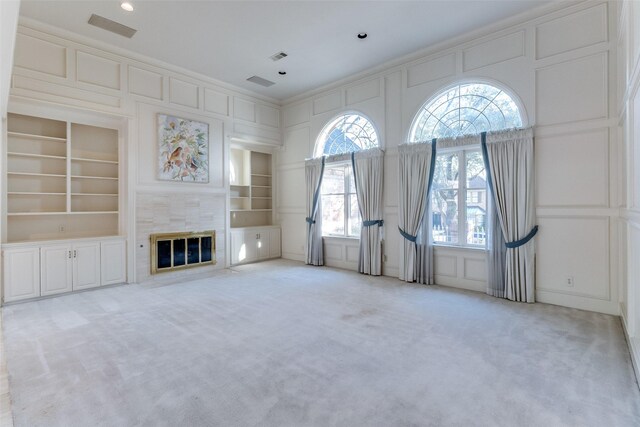 unfurnished room with crown molding and light colored carpet