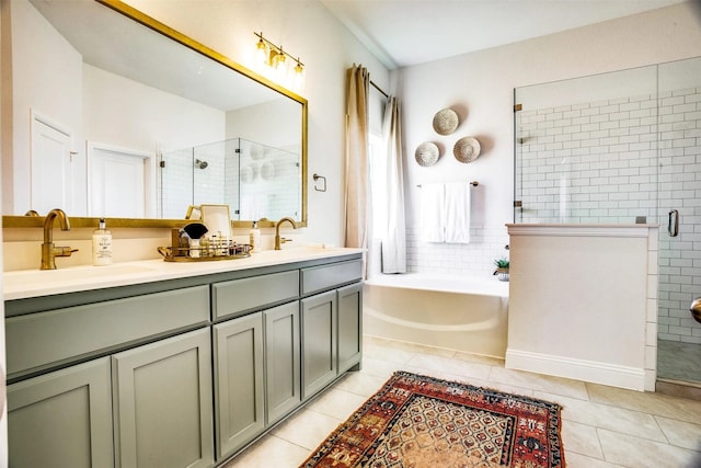 bathroom with a stall shower, a sink, a bath, and tile patterned floors