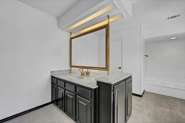 bathroom featuring vanity and a textured ceiling