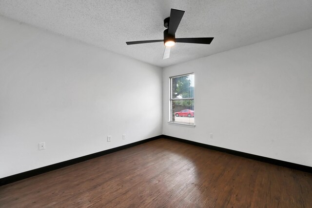 unfurnished room featuring ceiling fan, a textured ceiling, and dark hardwood / wood-style flooring