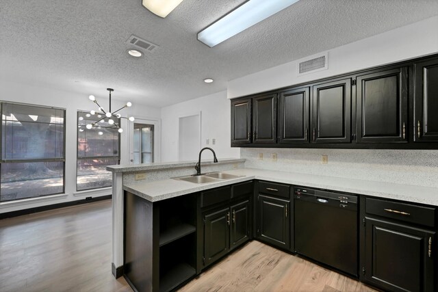 kitchen featuring black dishwasher, light hardwood / wood-style flooring, kitchen peninsula, sink, and a notable chandelier