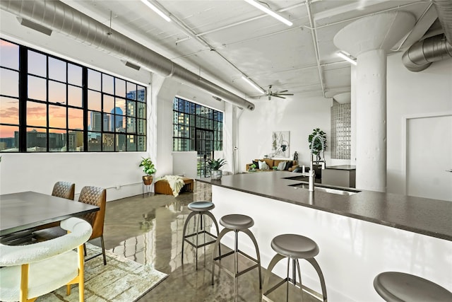 kitchen with ceiling fan, concrete flooring, and sink