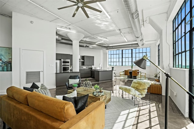 living room featuring sink and ceiling fan