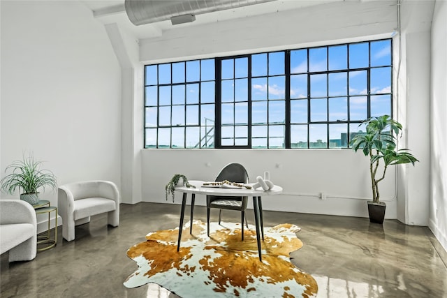 office with a wealth of natural light and concrete floors