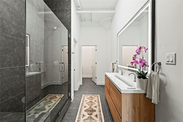 bathroom featuring vanity, tile patterned flooring, and a shower with shower door