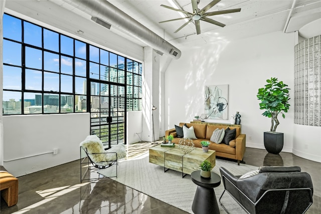 interior space featuring ceiling fan and concrete floors