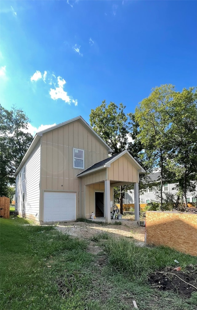 exterior space featuring a yard and a garage