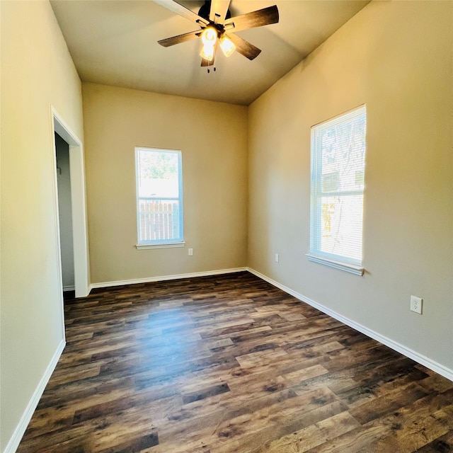 empty room featuring ceiling fan and dark hardwood / wood-style flooring